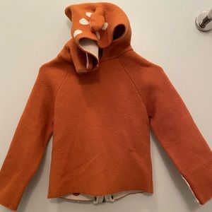 Baby Abaonannan sweater in orange with beige polka dots.